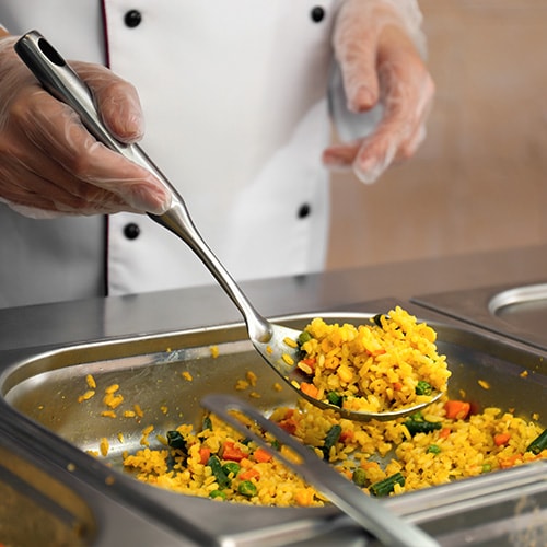chef serving rice from a food pan