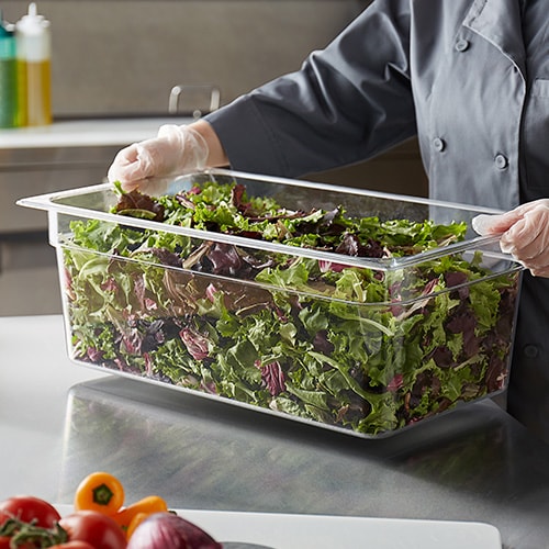 large clear container of mixed lettuce