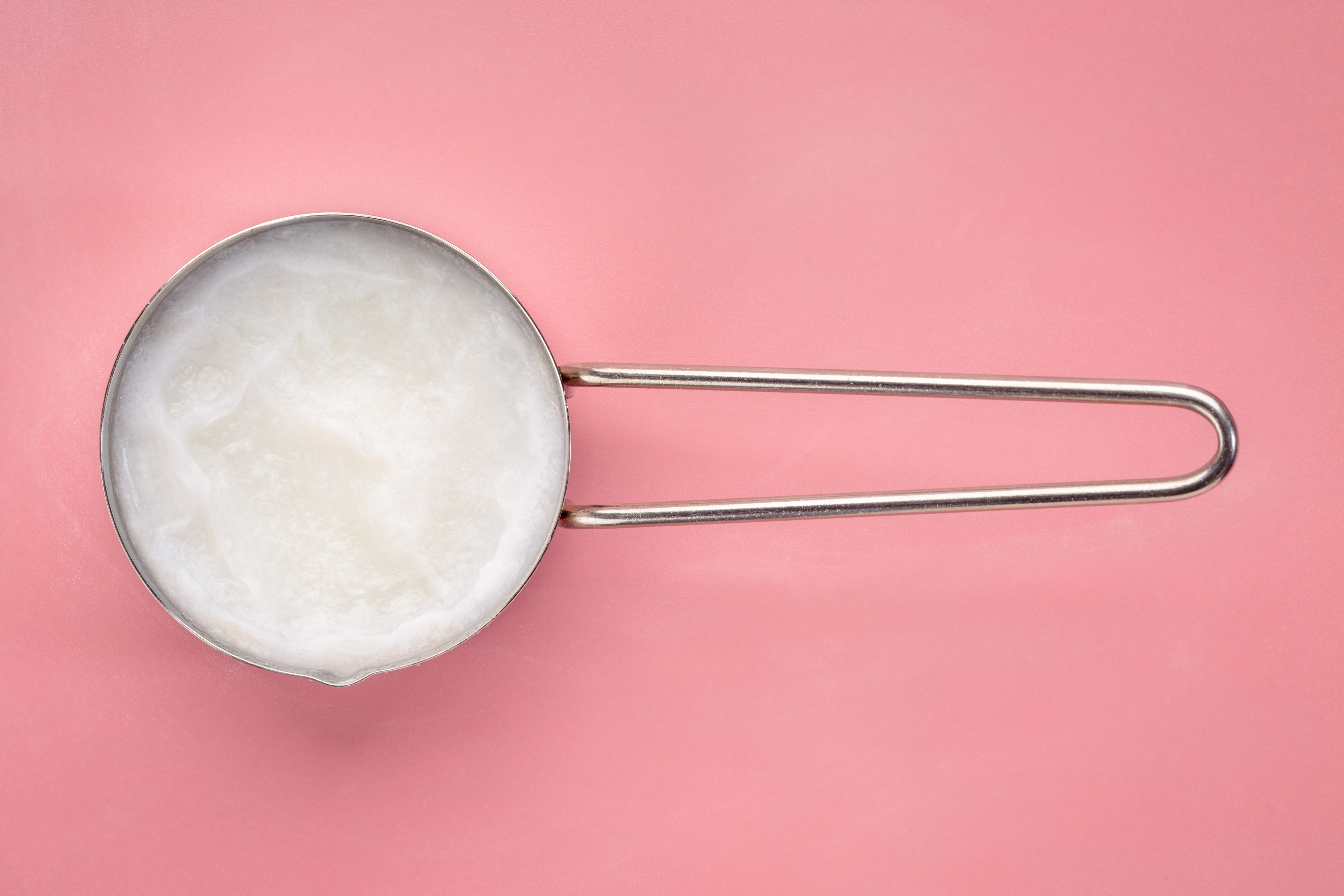 coconut cooking oil in a measuring scoop