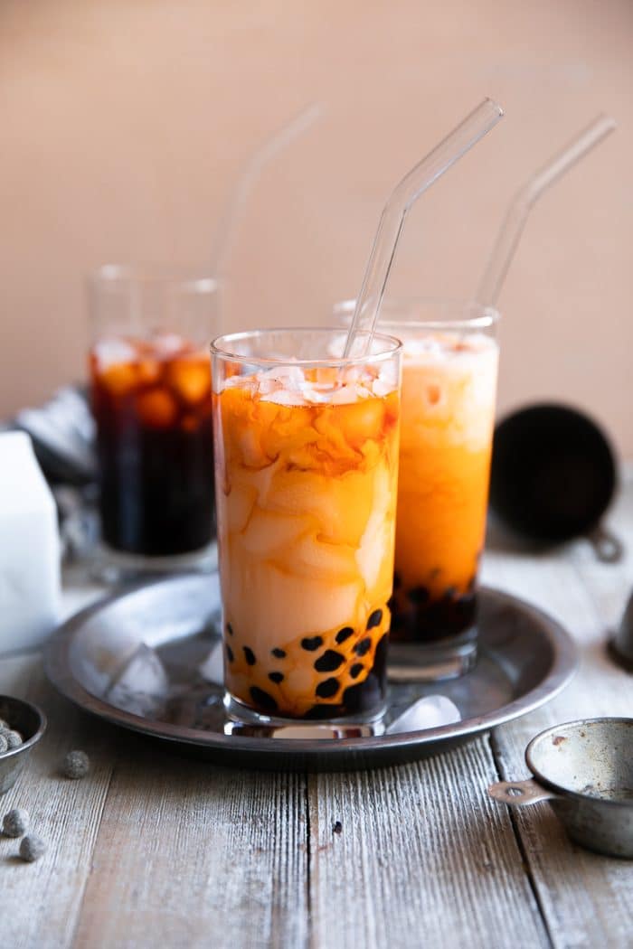 Two glasses filled with ice cold thai bubble tea.