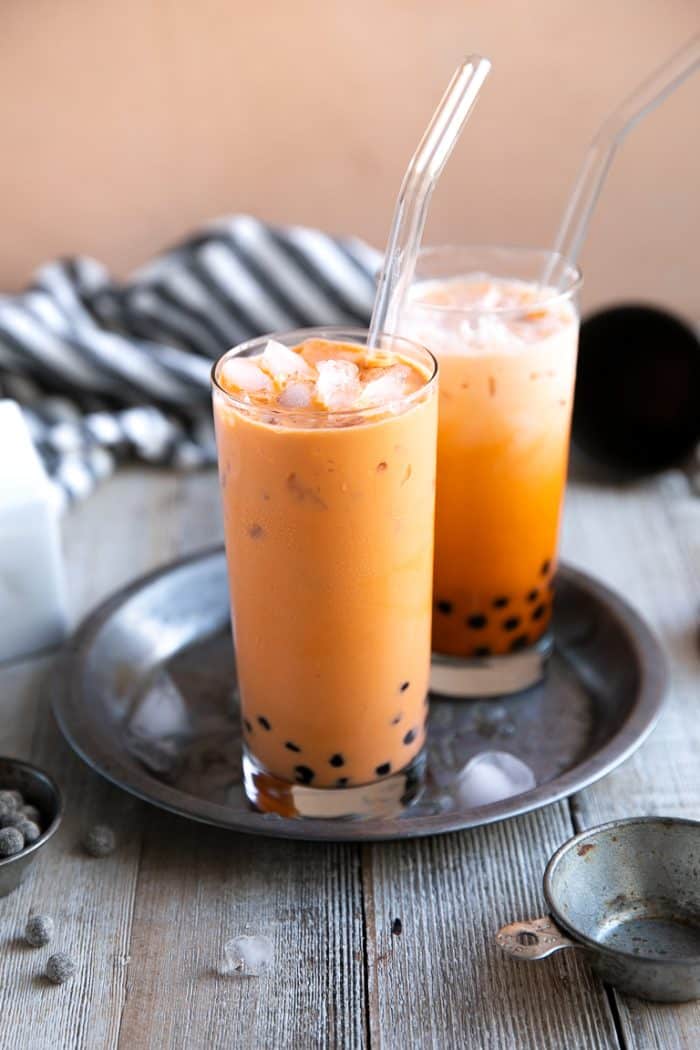 Glasses filled with ice cold thai tea and boba pearls.