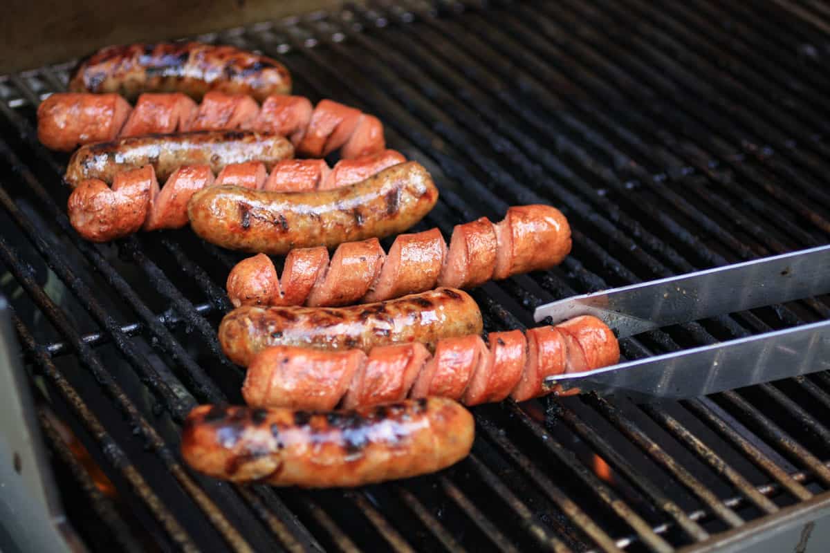 Hot dogs on a grill.
