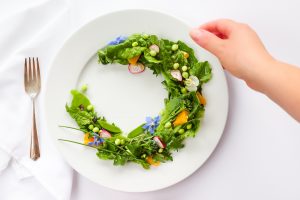 A bowl of colorful vegetable stew on a wooden table.