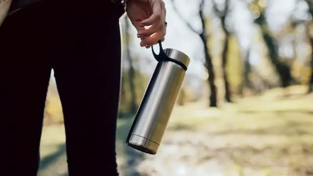 woman carrying water bottle