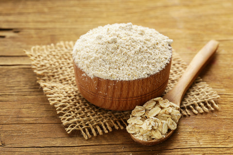 Natural organic Oat flour in a wooden bowl